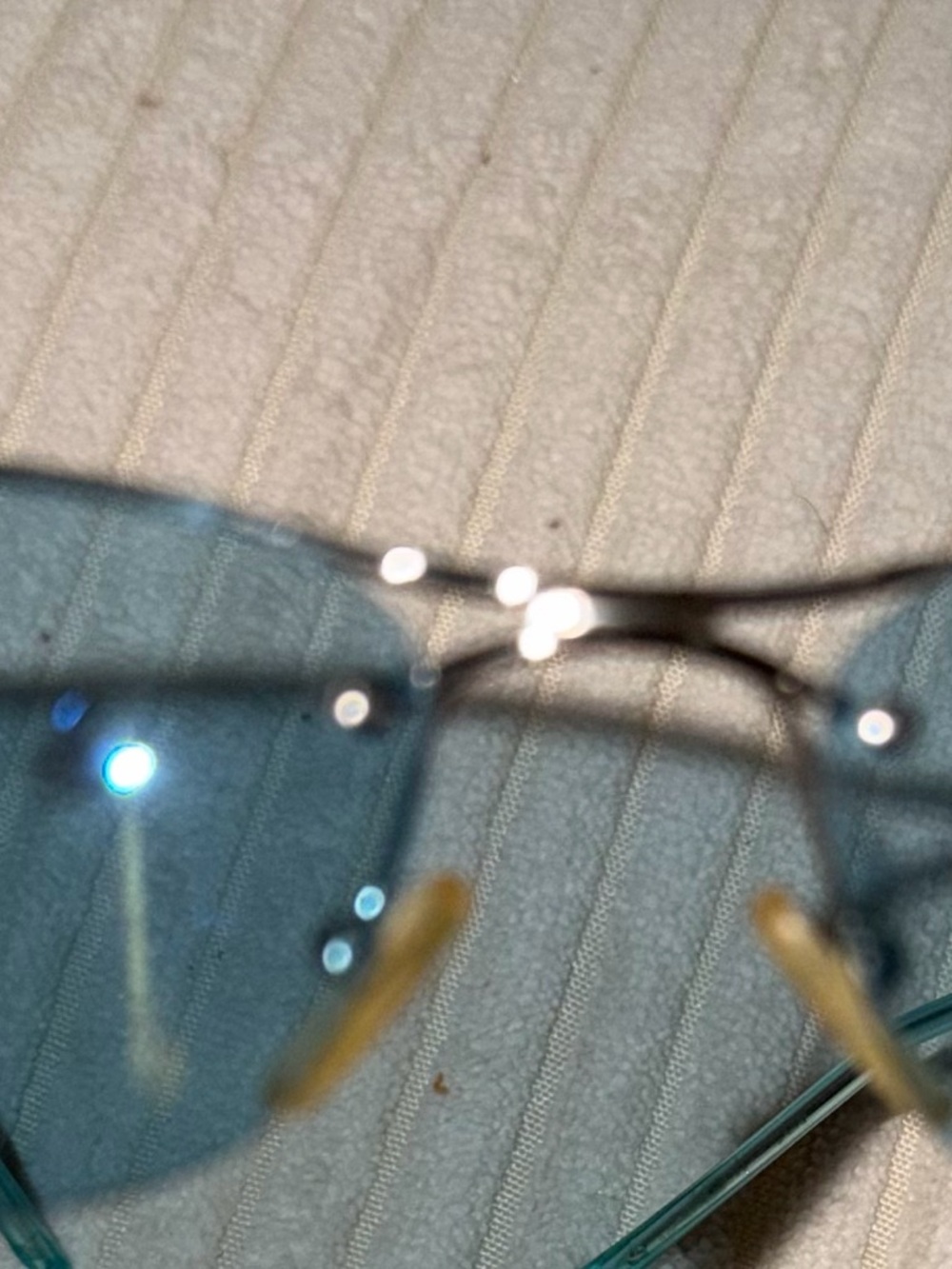 Dior Silver Logo Detail on Light Teal Surface - Picture 3 of 6